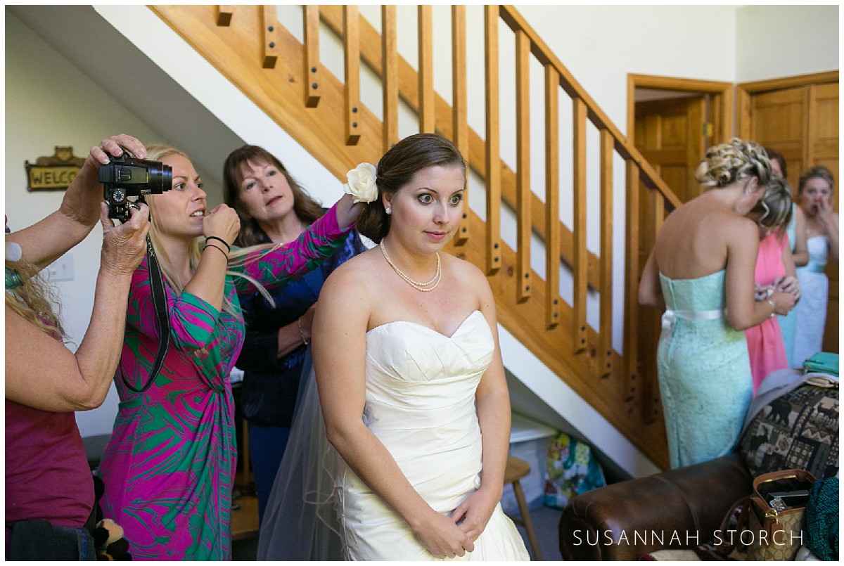 lots of ladies help a bride get ready