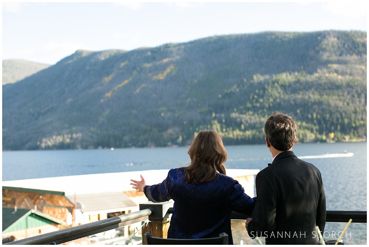 a wedding guest takes in the mountain and lake views