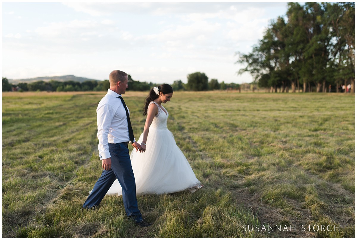 bride-and-groom-hold-hands-and-walk