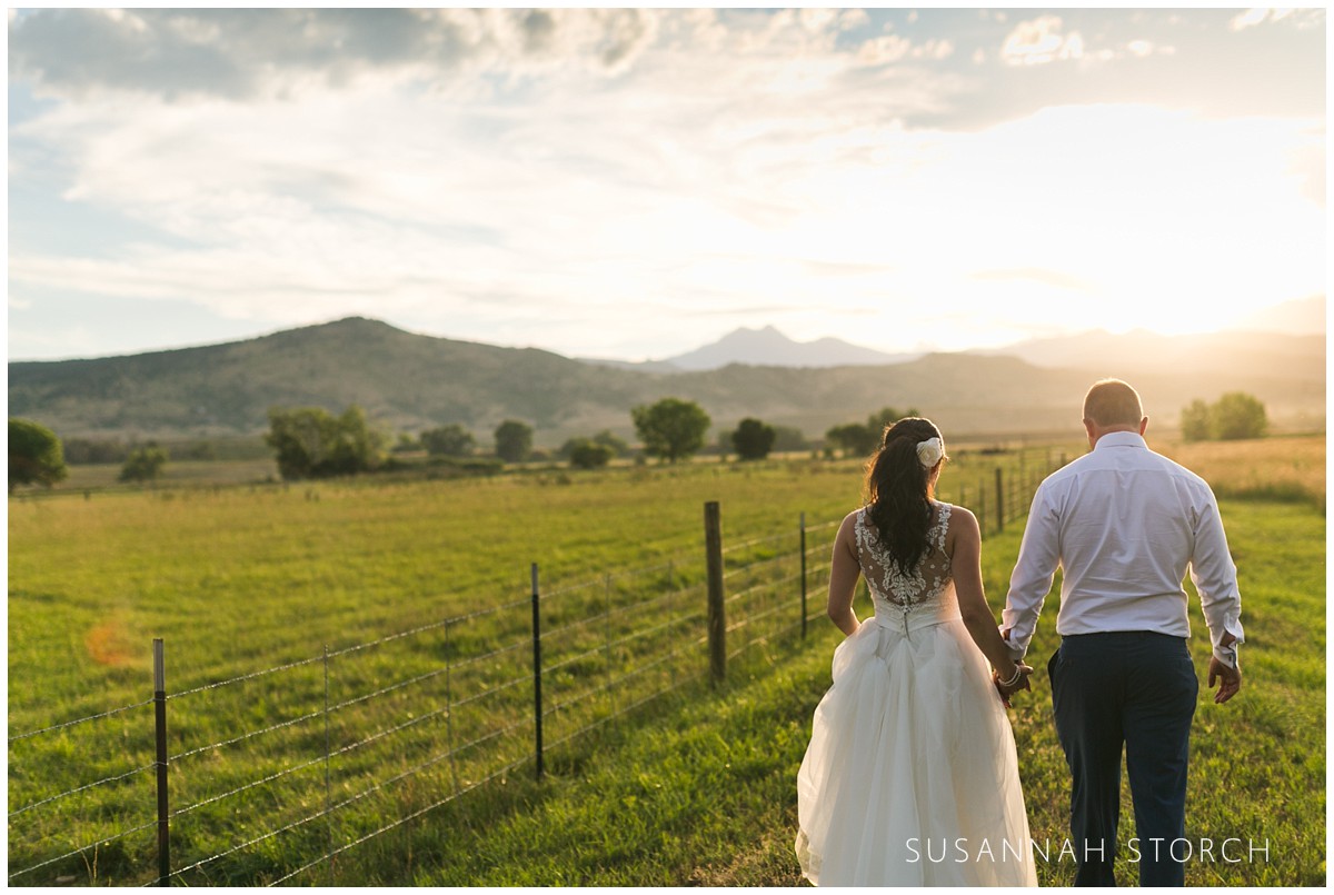 shupe-homestead-longmont-colorado-couple-hold-hands-and-walk