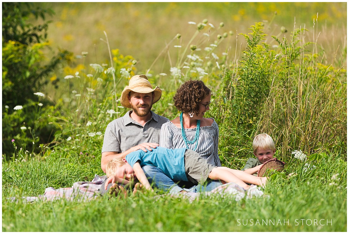 portrait of a vermont family sitting in grass