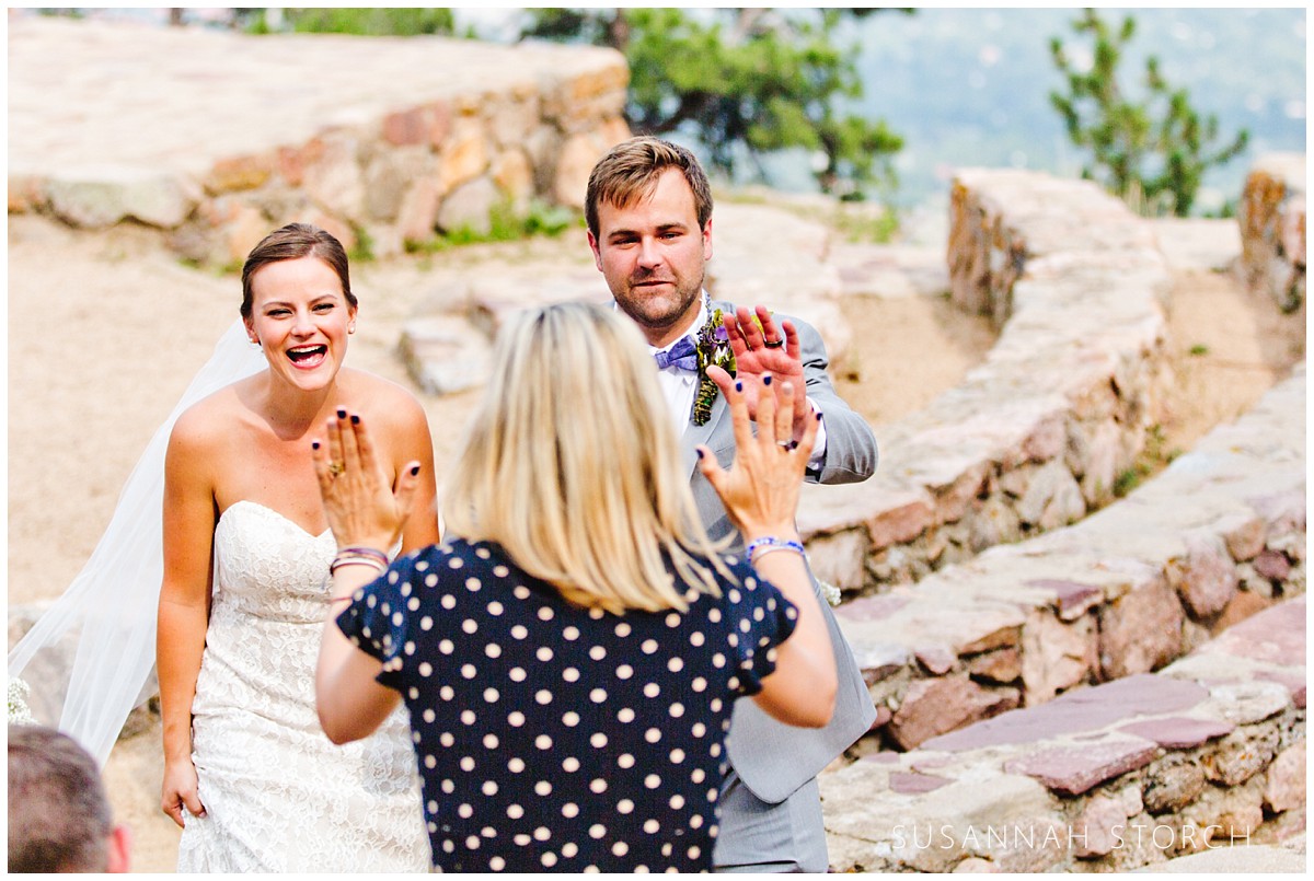 bride and groom approach a woman who wants to give high fives