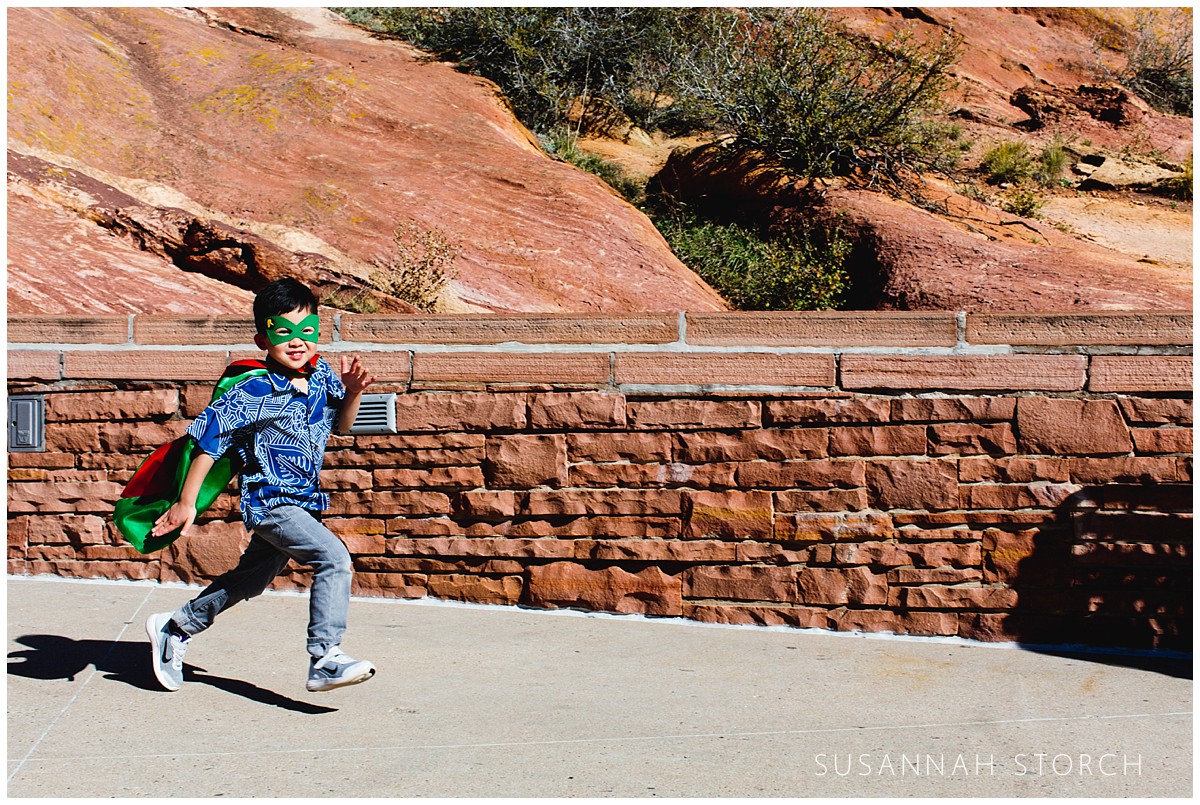 A boy runs at Red Rocks Amphitheater
