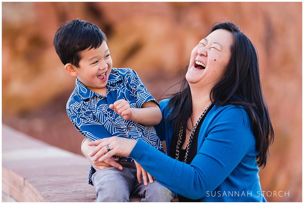 A happy family laughs during a Denver Colorado family session