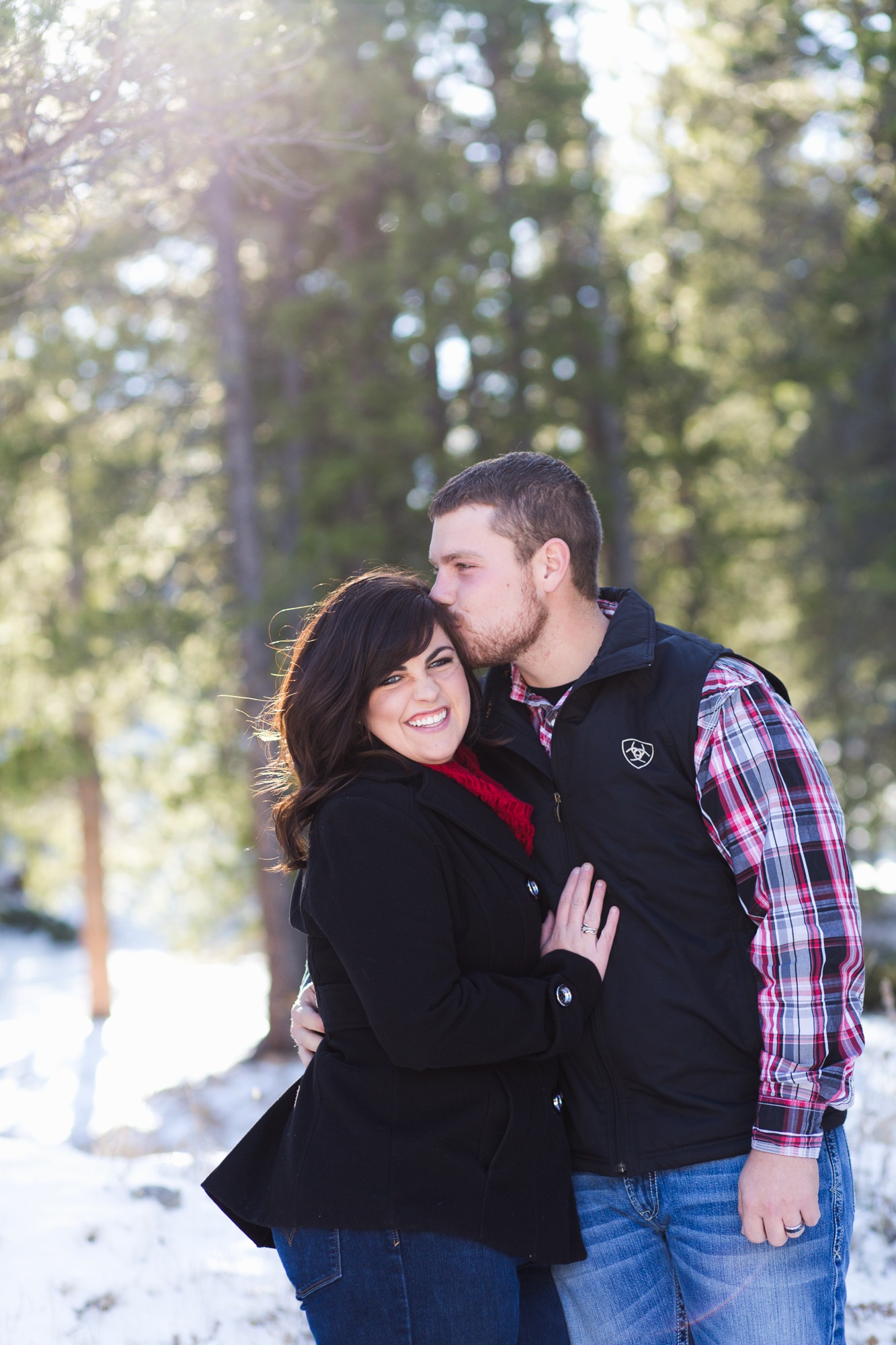 A portrait of a married couple during a winter family photo session in Nederland, Colorado.