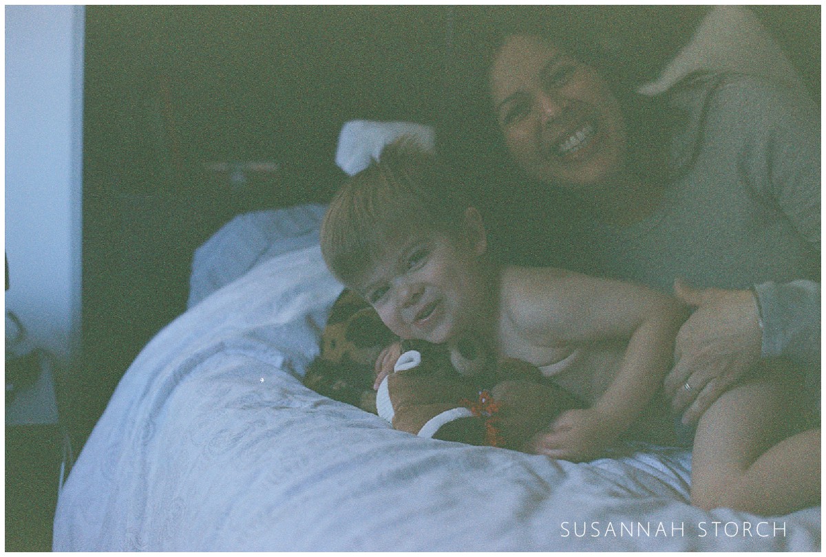 Expired film image of a laughing boy and his smiling mom
