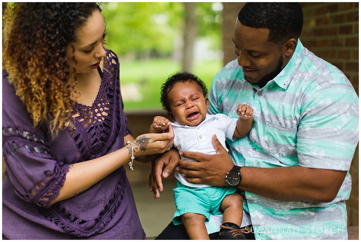 parents dote on a crying baby boy