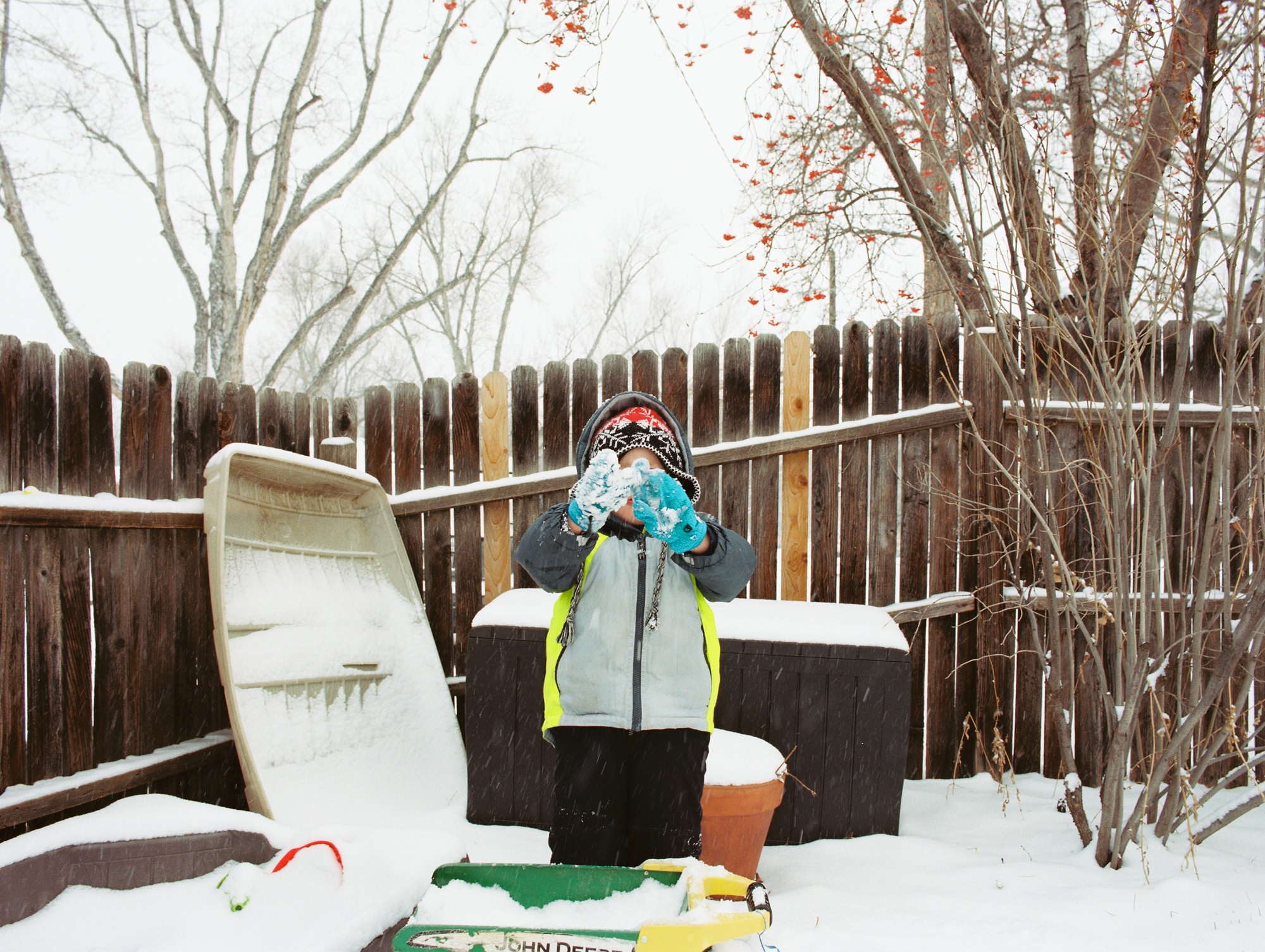 colorado boy playing in a snowy backyard