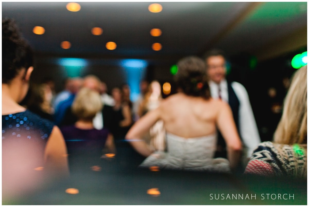 blurry image of a bride and groom dancing
