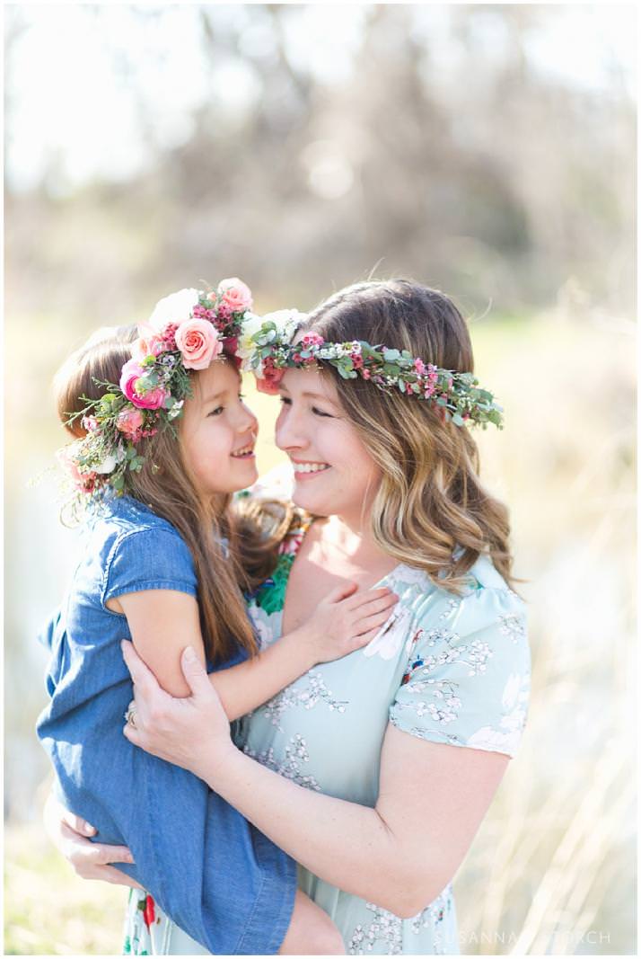 mom and daughter in floral crowns smile