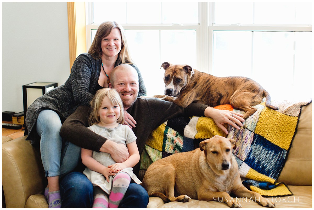 Three people and two dogs make up this family portrait
