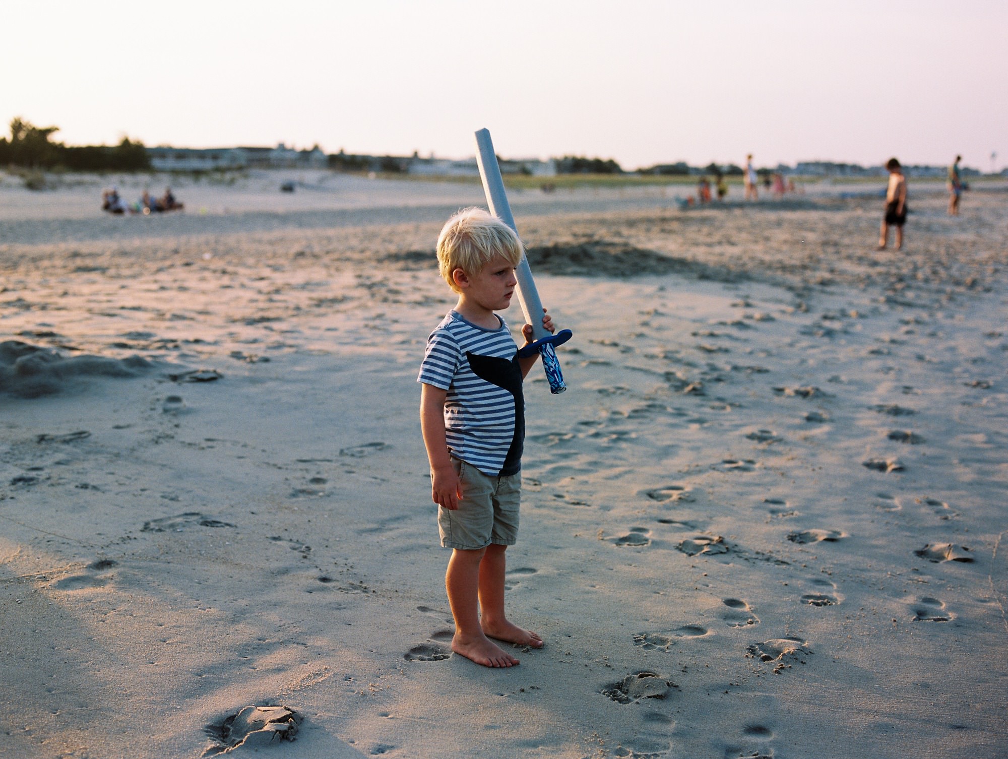 a boy holds a sword at bethany beach