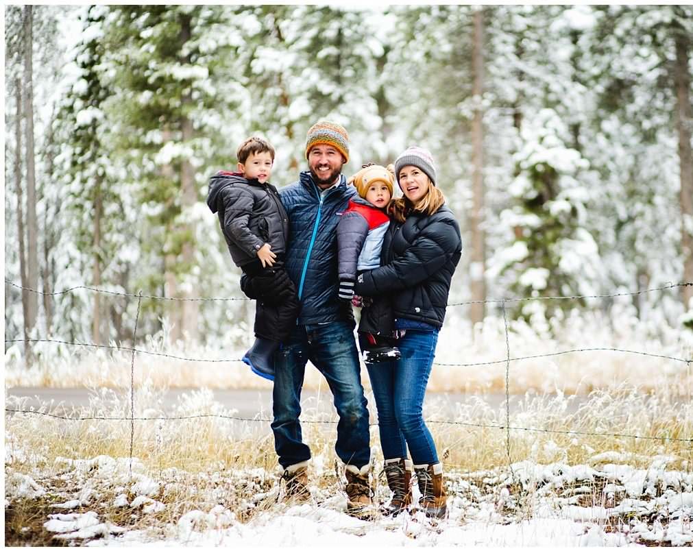family of four poses on some snow