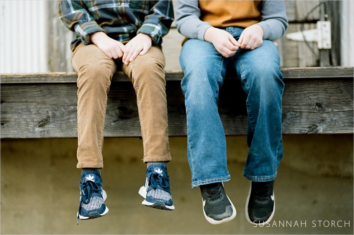 portraits of legs and shoes and laps of brothers