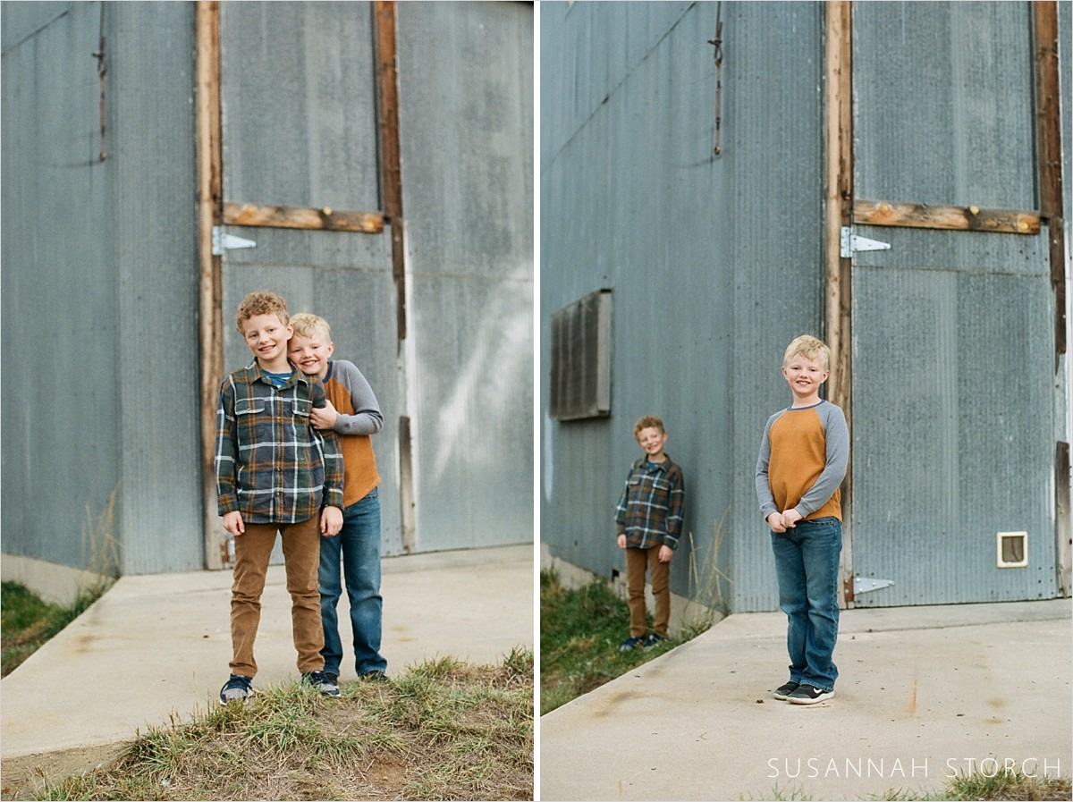 two images of boys standing by an old building