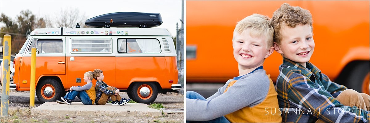 brothers sit by an orange vw bus