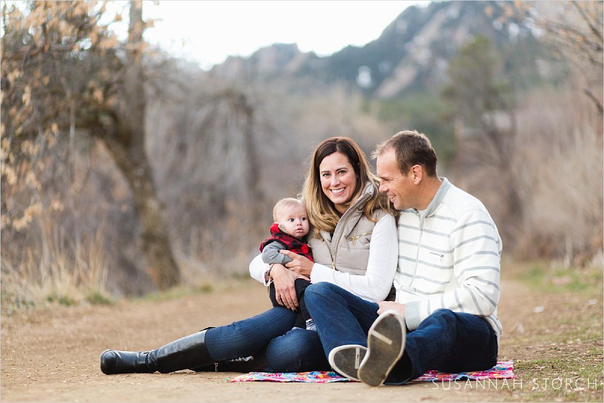 lifestyle family photography of a photoshoot with a baby taken in front of the mountains of boulder