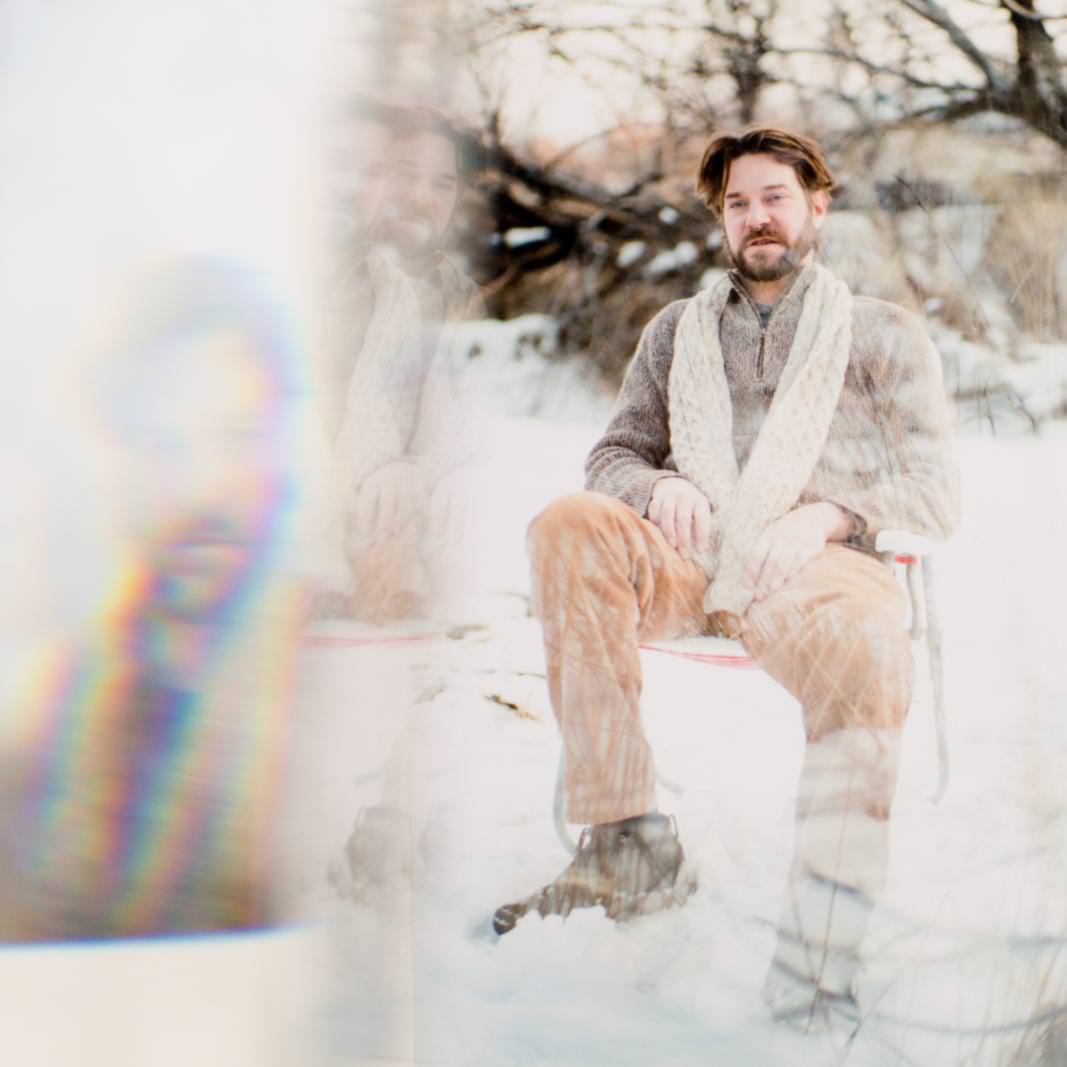 winter creative portrait of a boulder co man sitting in snow