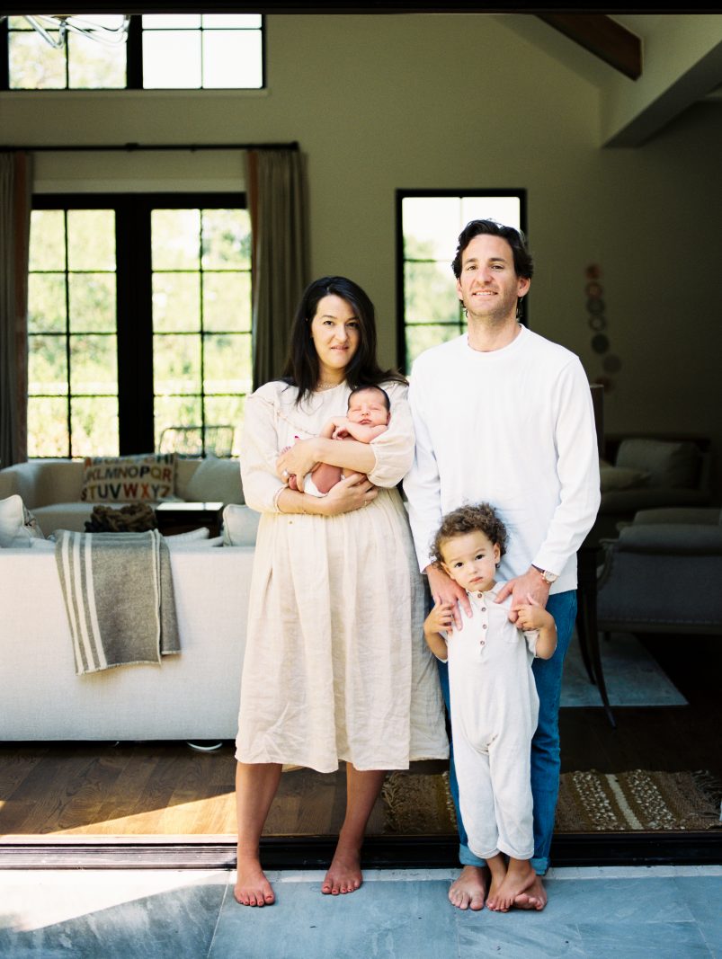 family of four stands in doorway in denver home