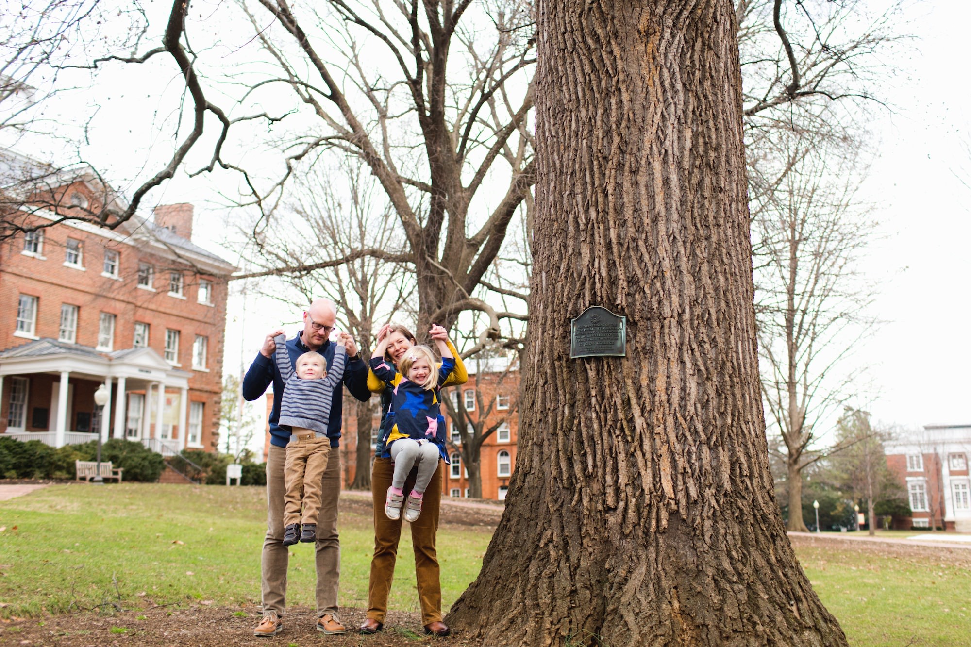 a family plays under a big tree in annapolis, md
