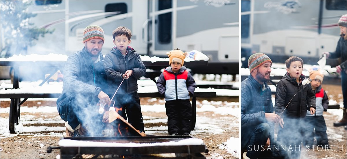 family makes smores in the snow