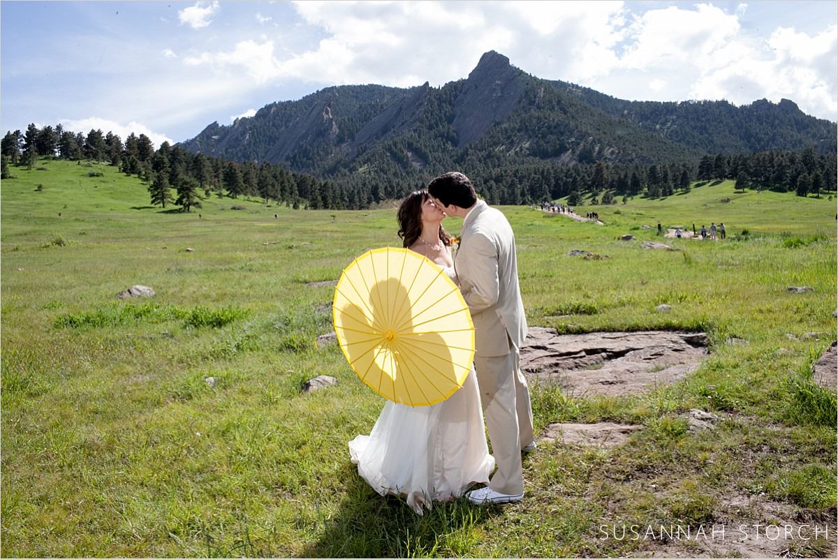 boulder wedding couple kiss with yellow umbrella