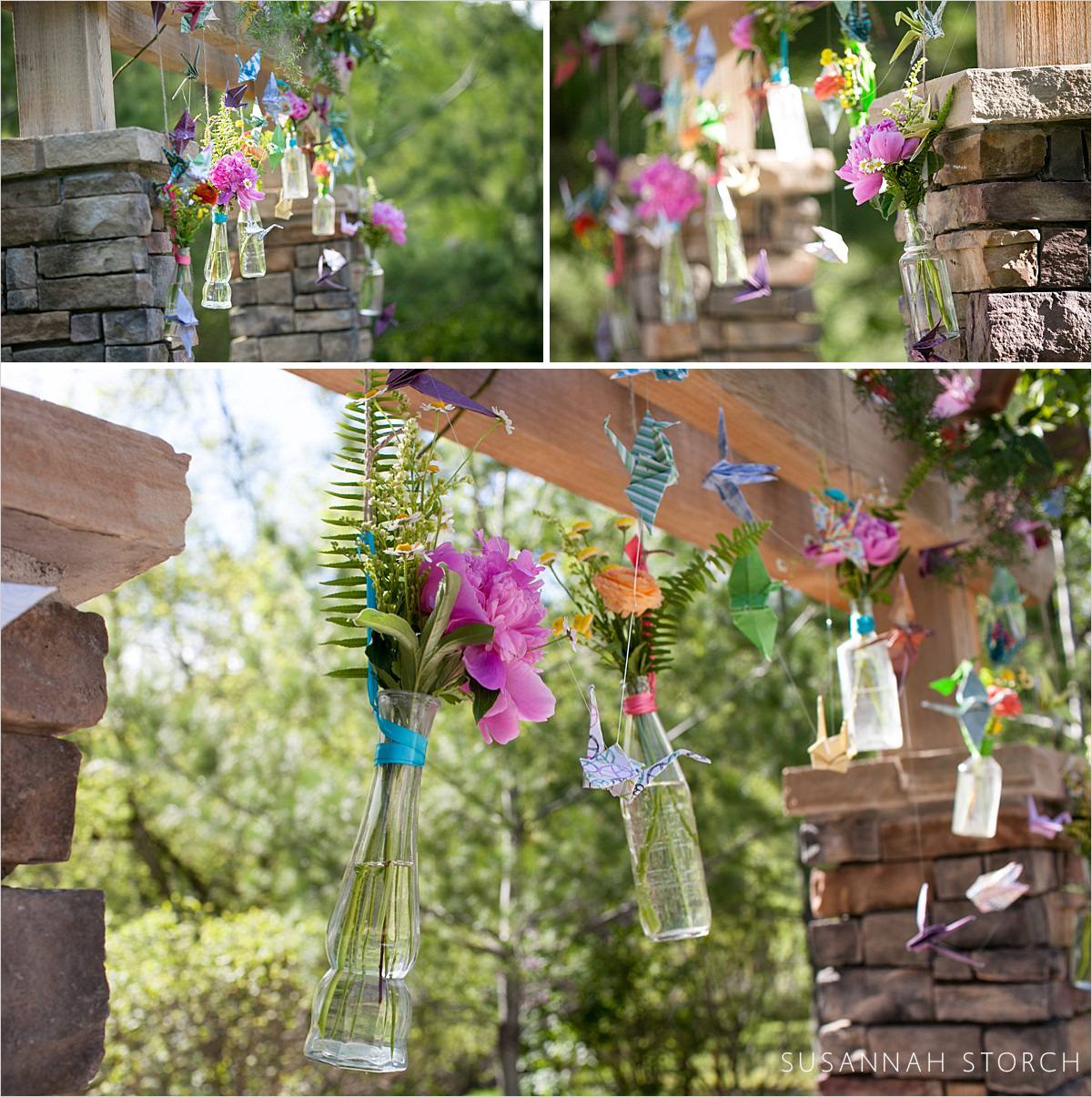 photos of colorful flowers in glass vases on an alter during a wedding at wedgwood creek