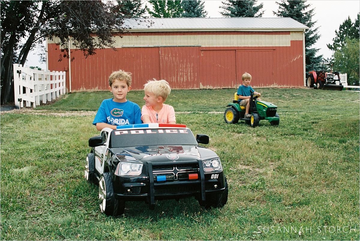 three boys ride vehicles