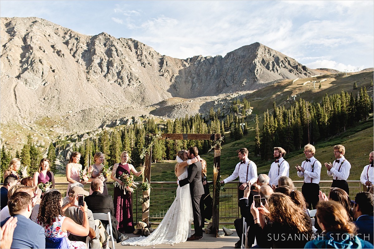 mountain wedding ceremony kiss