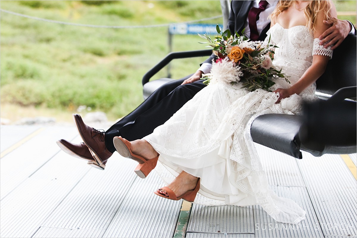 wedding couple about to step off a chairlift
