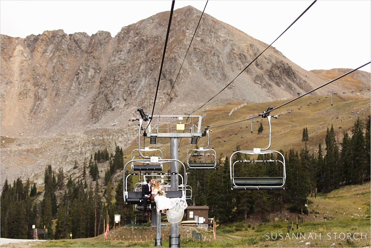 wedding couple ride a chairlift