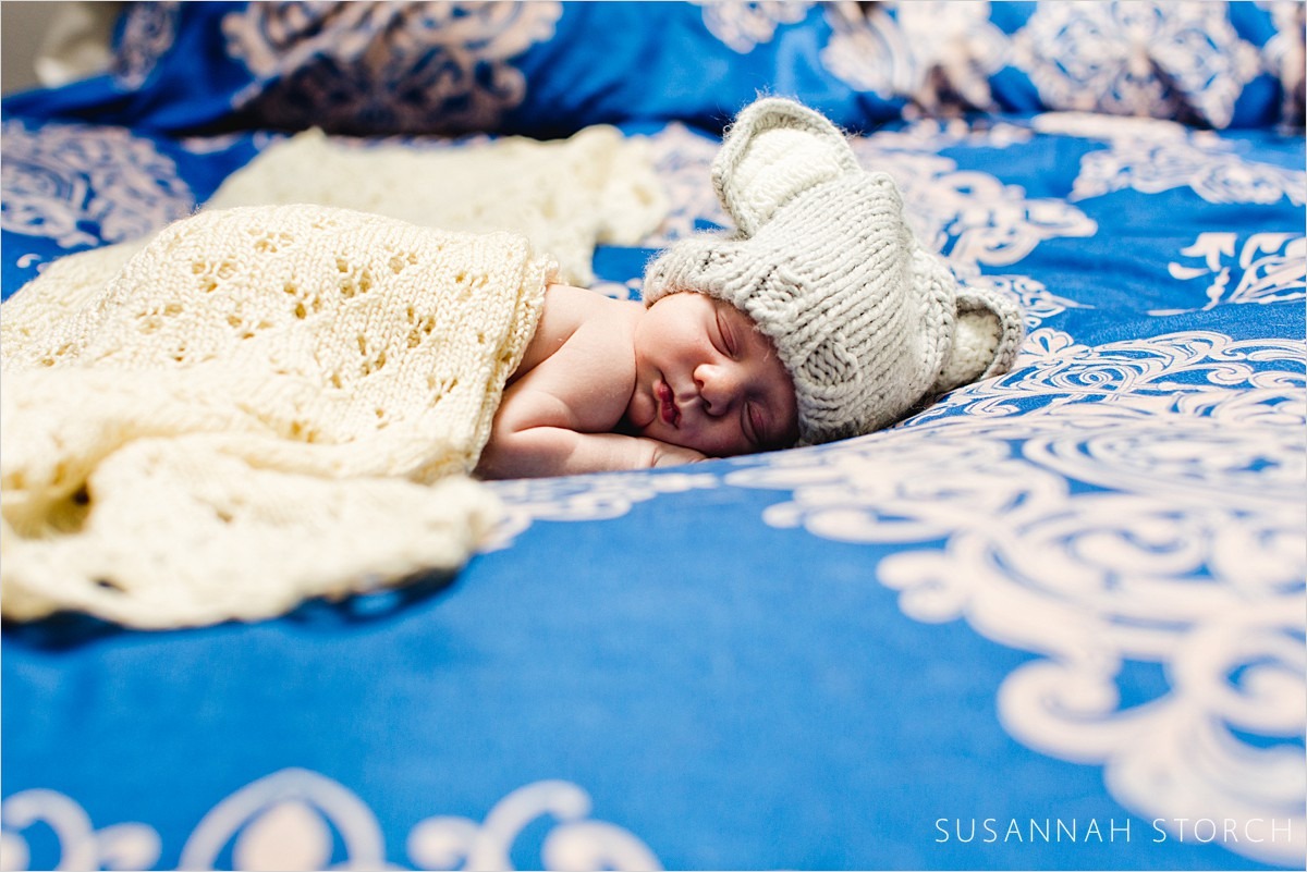sleeping newborn with knit ear hat
