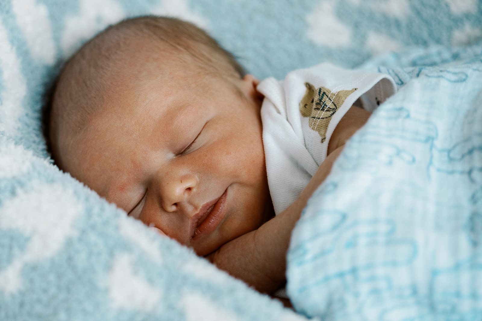 smiling newborn baby boy