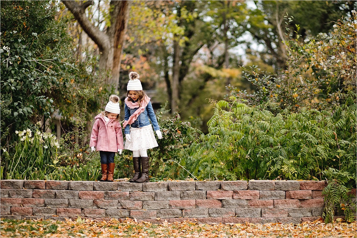 sisters stand by each other on a brick wall