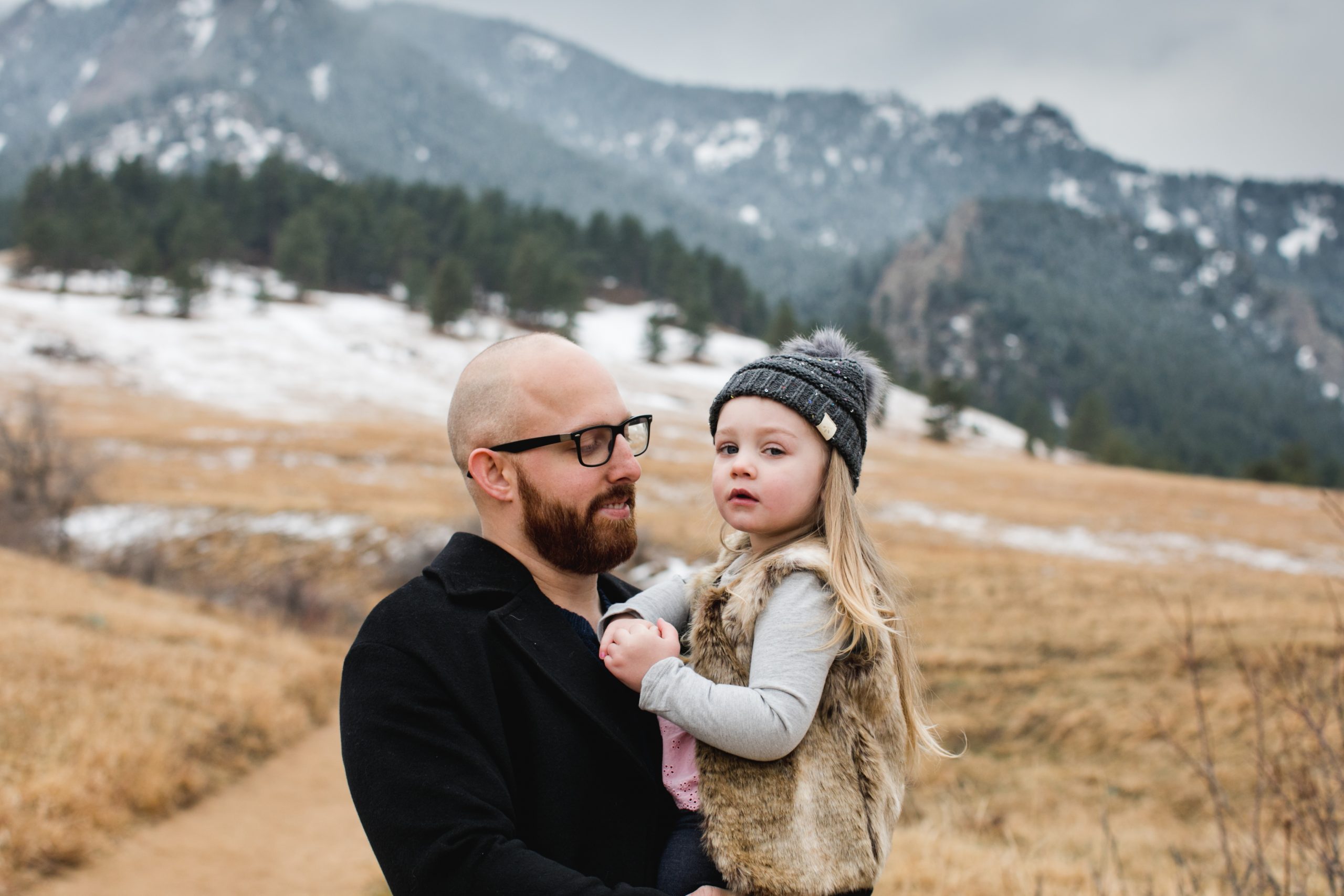dad holds daughter during photo session in boulder