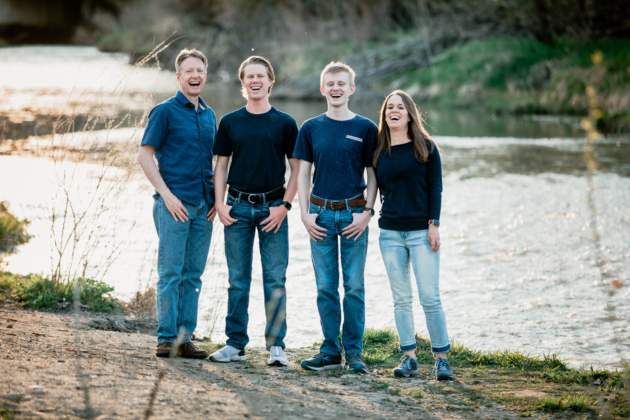 longmont family with teens standing by river during photography session