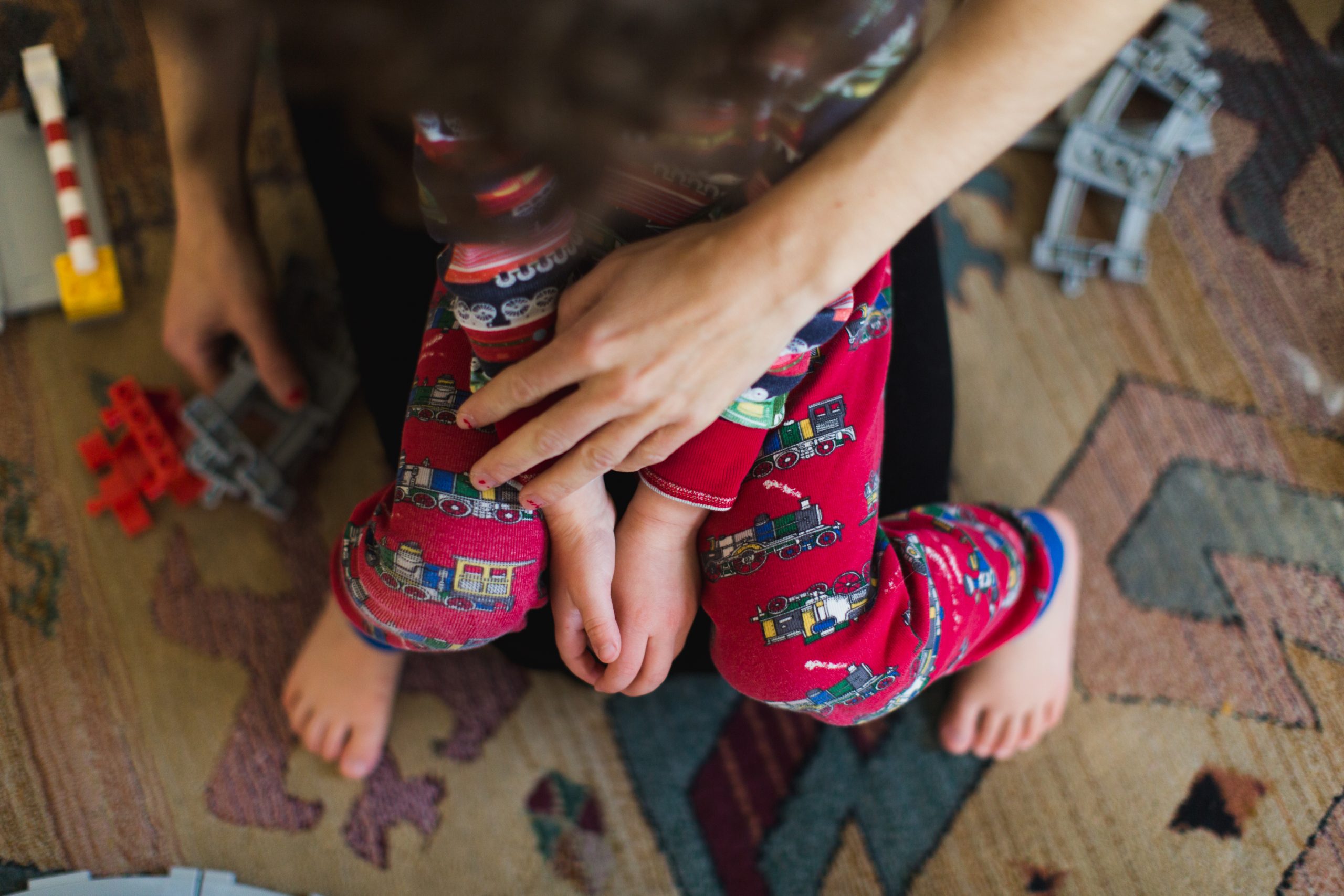mom puts hand on top of son's legs