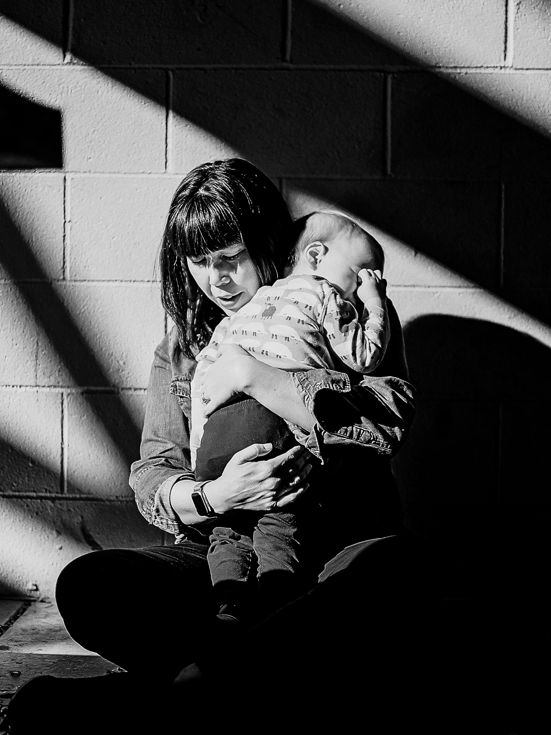 mom and baby snuggle in a black and white photo