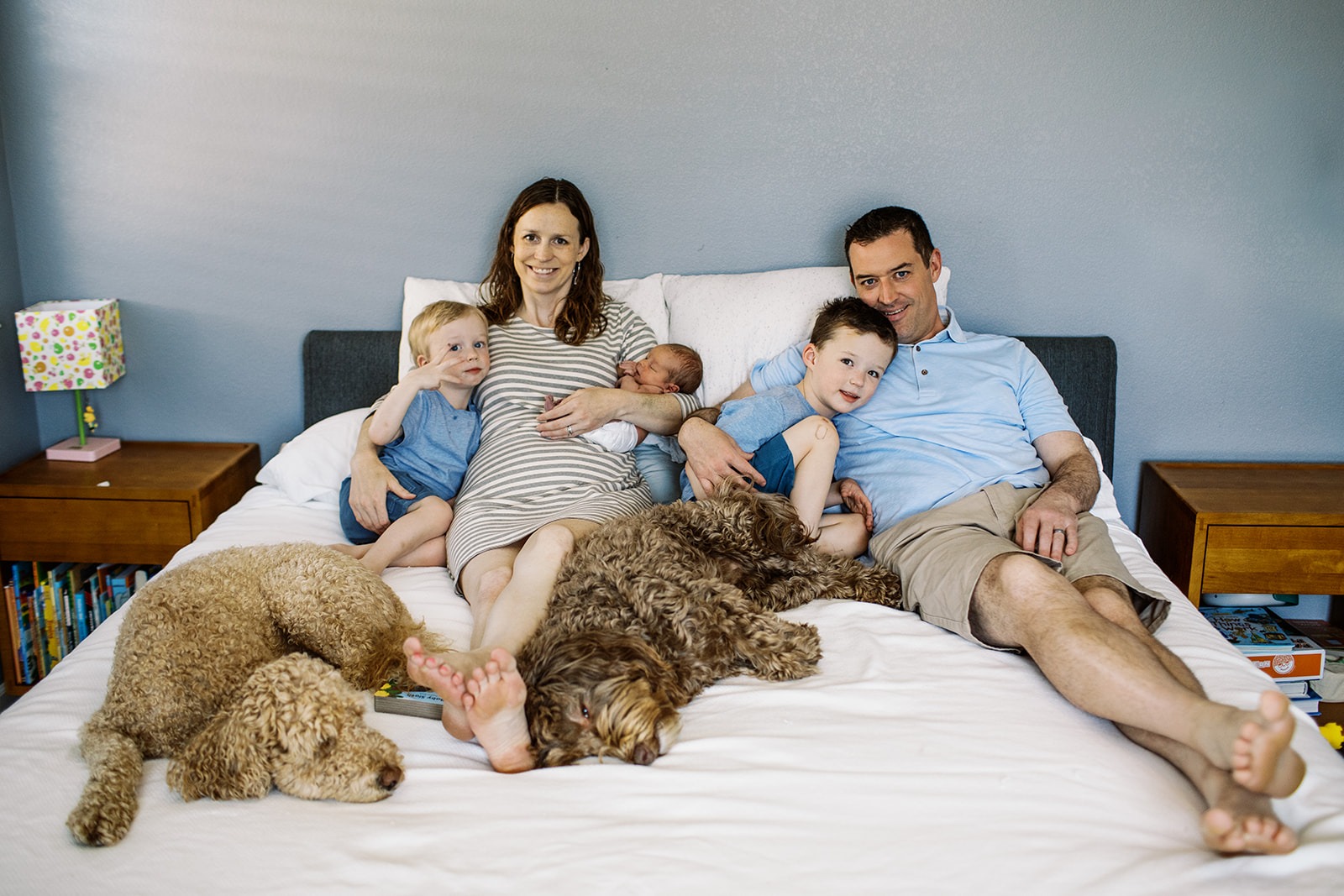 family snuggles on a bed during a family photo session