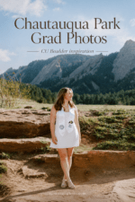 CU Boulder graduate in a white dress and graduation stole standing at Chautauqua Park with the Flatirons in the background.