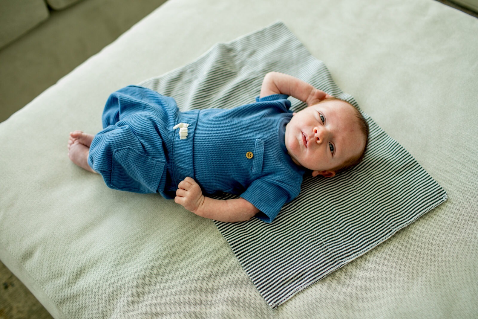 newborn baby lying on a blanket