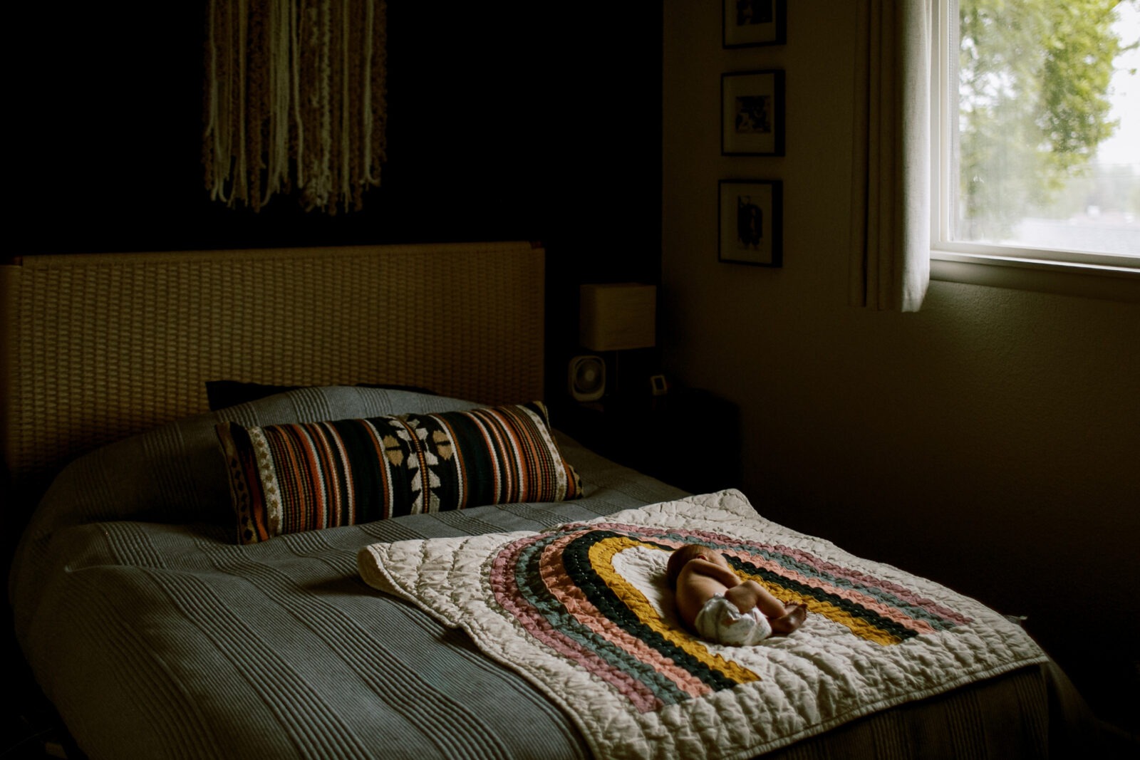 luxury newborn photography in longmont, colorado featuring a sleeping baby curled up on a blanket