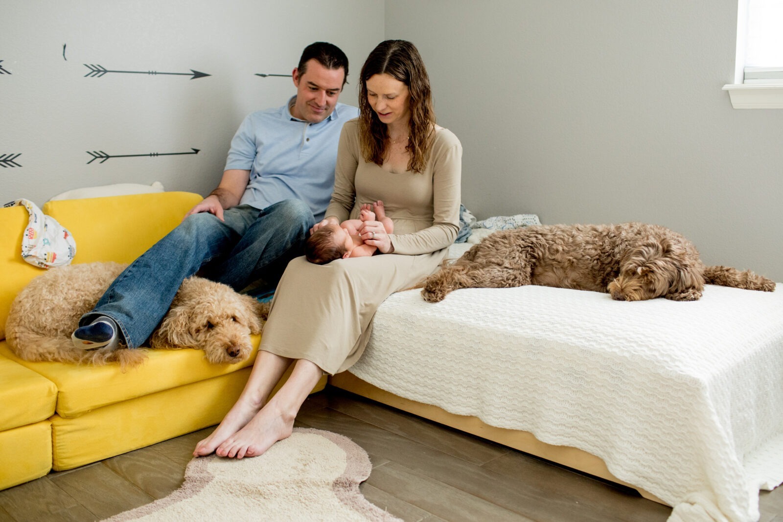 Erie, Colorado parents look at their newborn baby during an in-home newborn photo session