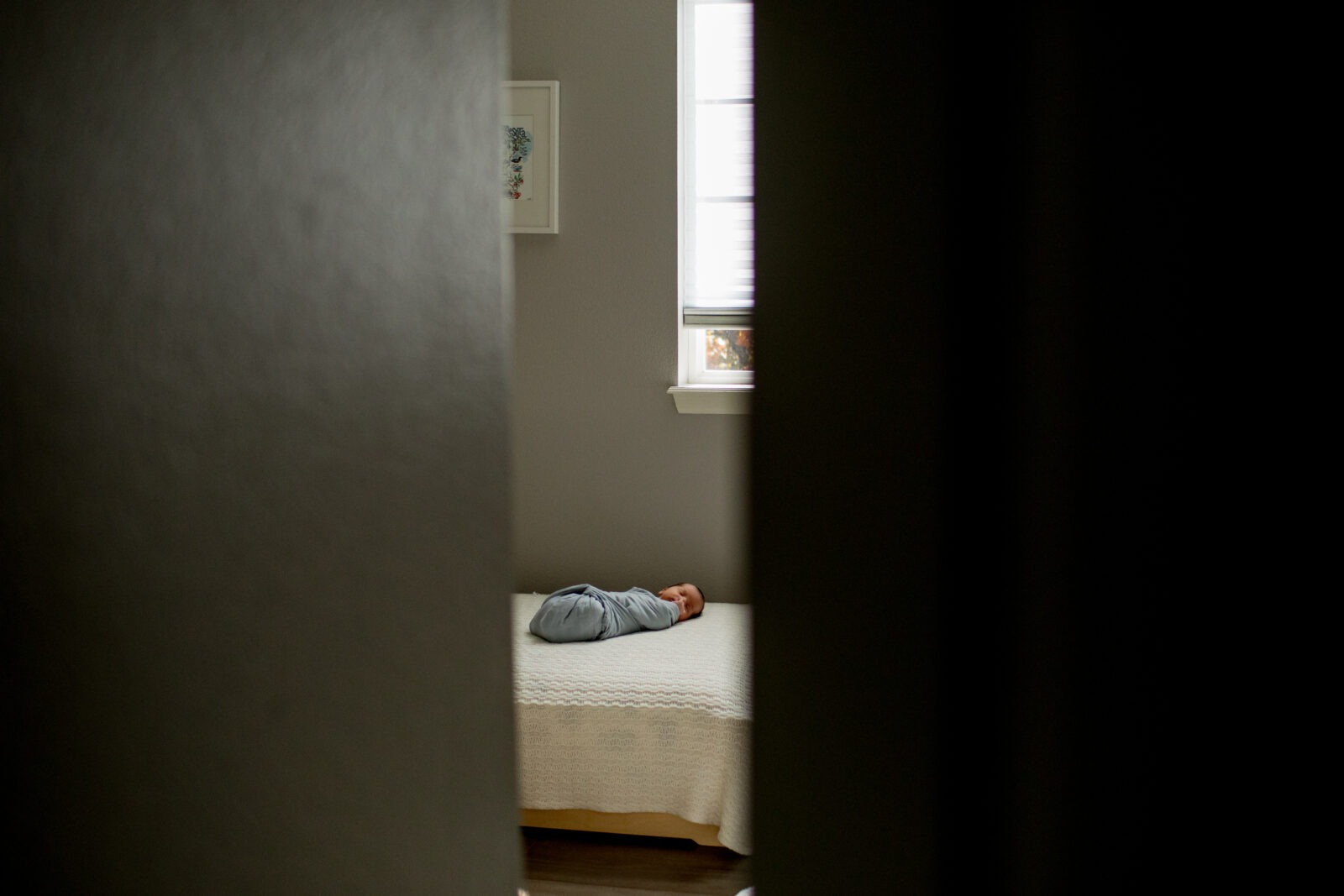 newborn baby sleeps on bed