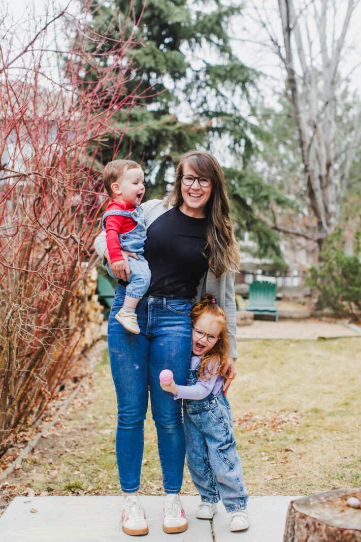 mother holding toddler outdoors during Colorado family photography session