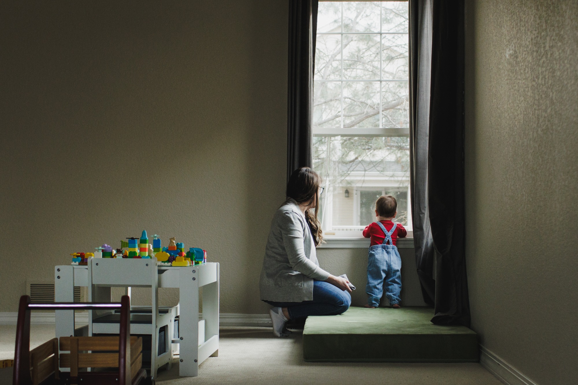 baby sitting near window during in-home family photography session
