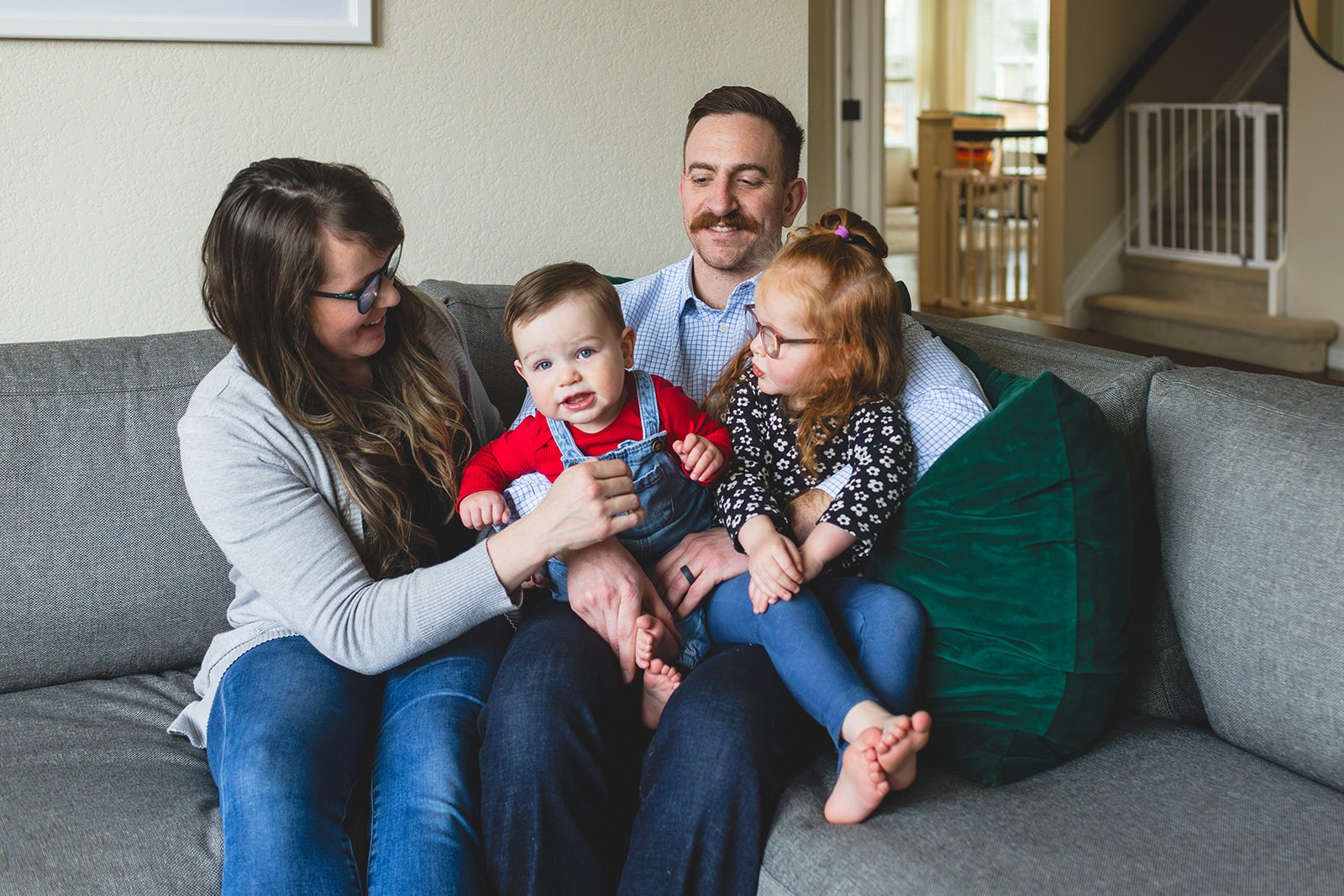 family sitting together on couch during in-home family photography session in Longmont, Colorado