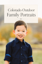 Smiling young boy in a navy shirt during a Colorado outdoor family portrait session in Golden.