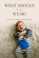 Newborn baby boy in striped onesie and gray cardigan during in-home newborn photography session in Colorado
