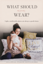 om in light dusty pink top holding newborn baby on bed during in-home newborn photography session in Colorado